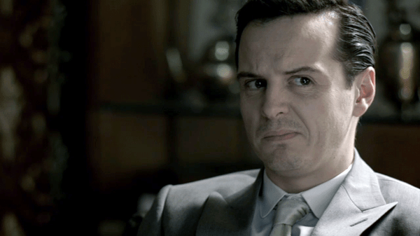 S2E3_moriarty-making-a-skeptical-facein-grey-suit